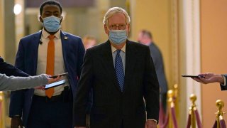 Senate Majority Leader Mitch McConnell of Ky. walks past reporters on Capitol Hill in Washington, Dec. 15, 2020.