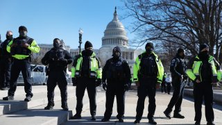 Members of the Metropolitan Police Department of the District of Columbia are seen in front of the U.S. Capitol a day after a pro-Trump mob broke into the building on Jan. 7, 2021, in Washington, DC.