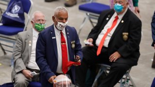 New Hampshire Rep. Al Baldasaro (R-Londonderry) wears a "Trump 2020" face mask as he walks among his colleagues during a legislative session in Durham, June 11, 2020, at the Whittemore Center at the University of New Hampshire.