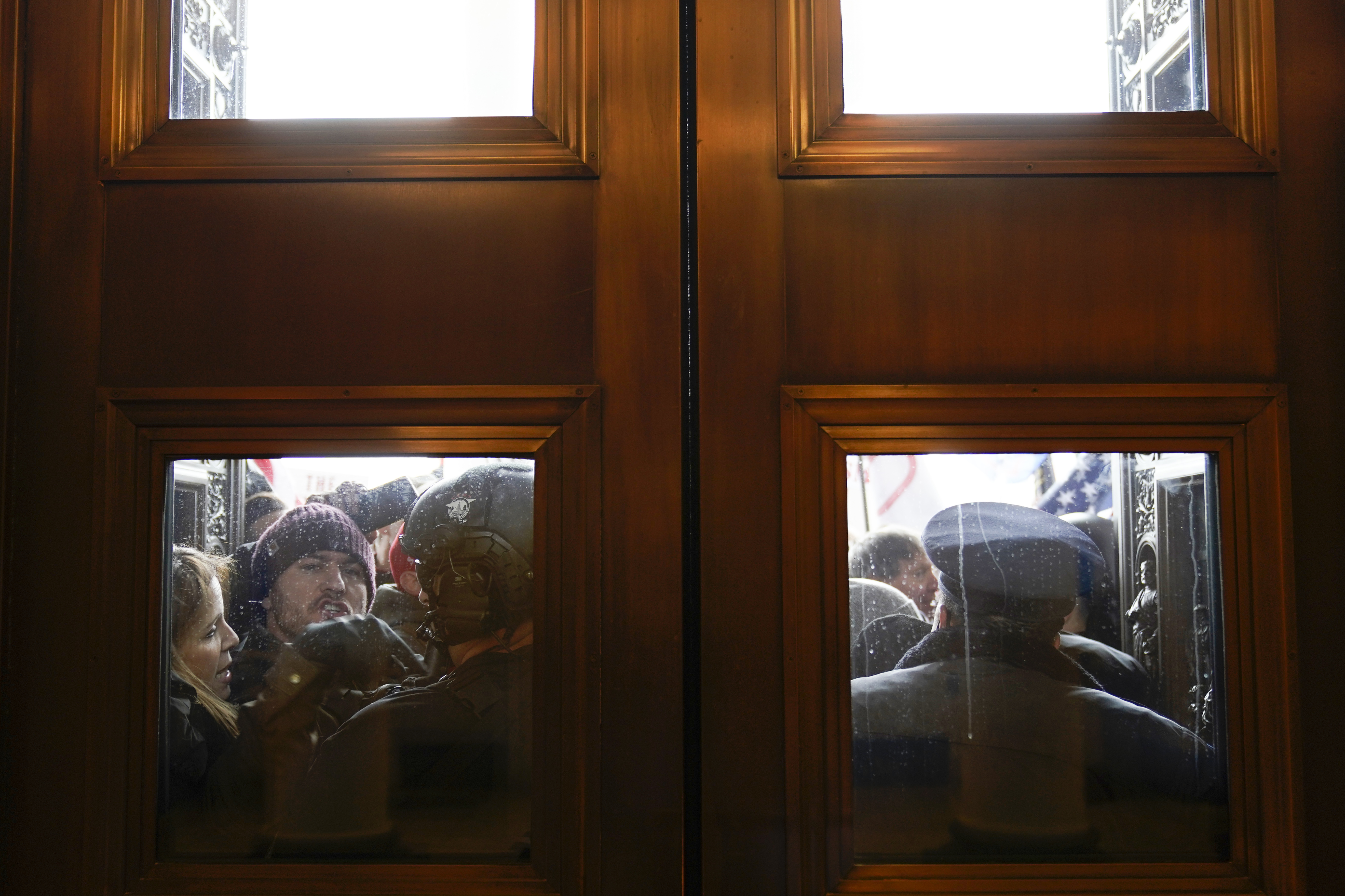 Capitol police try to hold back protesters outside the east doors to the House side of the  Capitol in Washington, DC, Jan. 6, 2021.