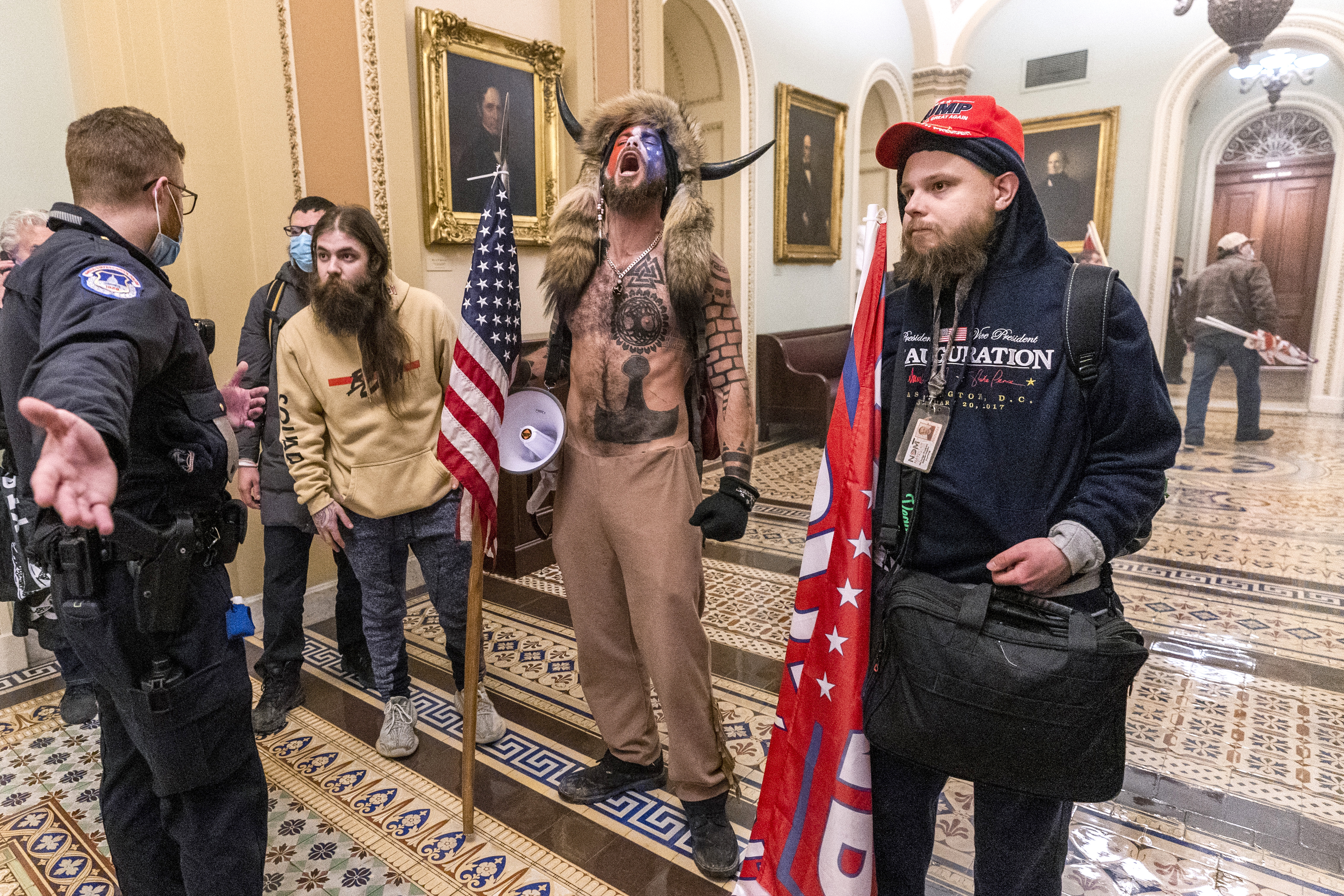 Supporters of President Donald Trump are confronted by Capitol Police officers outside the Senate Chamber inside the Capitol, Wednesday, Jan. 6, 2021 in Washington. (AP Photo/Manuel Balce Ceneta)