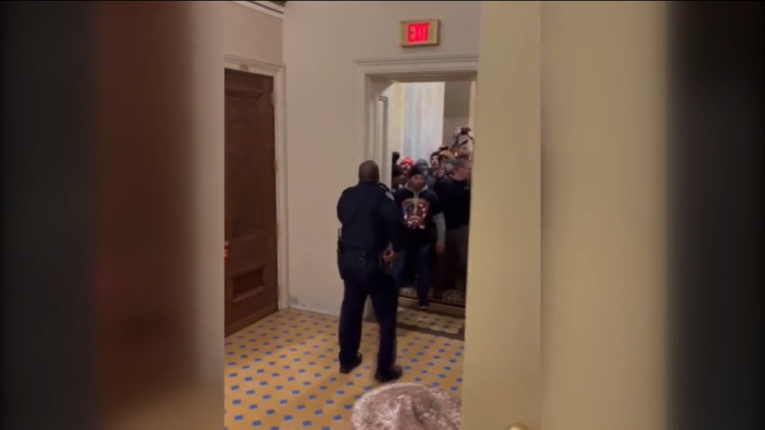 Still frame of video shot of rioters breeching capitol building