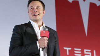 FILE - Tesla Motors CEO Elon Musk speaks to the media. Tesla says it has invested more than $1 billion in Bitcoin and will accept the digital currency as payment for its electric vehicles.