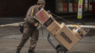 A United Parcel Service Inc. (UPS) driver delivers boxes in New York, U.S., on Tuesday, Oct. 13, 2020.