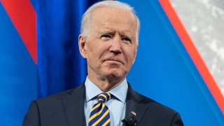 In this Feb. 16, 2021, file photo, President Joe Biden holds a face mask as he participates in a CNN town hall at the Pabst Theater in Milwaukee, Wisconsin.