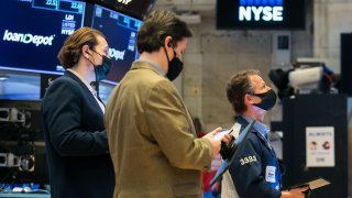 Traders work on the floor of the New York Stock Exchange.