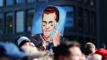This Feb. 5, 2019, file photo shows a fan's picture of then-New England Patriots quarterback Tom Brady and his six Super Bowl rings during the Patriots' Super Bowl victory parade through the streets of Boston.