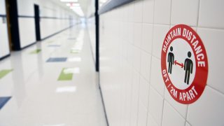 ALEXANDRIA, VA – FEBRUARY 16: A social distancing sign is seen at Bucknell Elementary School on Tuesday February 16, 2021 in Alexandria, VA. Fairfax County Public Schools reopened Tuesday for some students. (Photo by Matt McClain/The Washington Post via Getty Images)