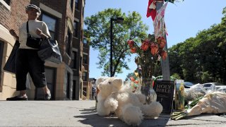 This Aug. 29, 2014, file photo shows a make-shift memorial at the corner of Blue Hill Avenue and Charlotte Street, where Dawnn Jaffier was shot the day of the Caribbean Festival.