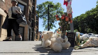 This Aug. 29, 2014, file photo shows a make-shift memorial at the corner of Blue Hill Avenue and Charlotte Street, where Dawnn Jaffier was shot the day of the Caribbean Festival.
