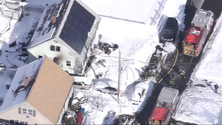 Firefighters at the scene of a house fire in Lowell, Massachusetts