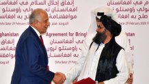 U.S. Special Representative for Afghanistan Reconciliation Zalmay Khalilzad, left, and Taliban co-founder Mullah Abdul Ghani Baradar shake hands after signing a peace agreement during a ceremony in the Qatari capital Doha on Feb. 29, 2020.
