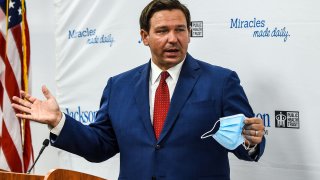 Florida Gov. Ron DeSantis speaks holding his facemask during a press conference to address the rise of coronavirus cases in the state, at Jackson Memorial Hospital in Miami, on July 13, 2020.