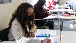 Giani Clarke,18, a senior at Wilson High School, takes a test in her AP Statistics class. The desks are doubled as a way to provide more social distancing.