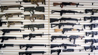 FILE - In this Oct. 2, 2018, file photo, semi-automatic rifles fill a wall at a gun shop in Lynnwood, Wash. With Democrats controlling the presidency and Congress, Republican state lawmakers concerned about the possibility of new federal gun control laws aren't waiting to react. Legislation in at least a dozen states seeks to nullify any new restrictions, such as ammunition limits or a ban on certain types of weapons.
