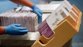 FILE - In this Nov. 1, 2020, file photo, envelopes containing ballots are shown at a San Francisco Department of Elections at a voting center in San Francisco. A new study finds the expansion of mail voting did not benefit Democrats or increase turnout.