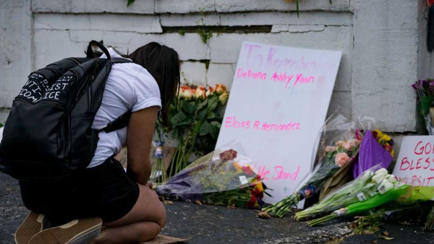 Flowers and signs adorn Gold Spa where activists demonstrated against violence against women and Asians following Tuesday night’s shooting where three women were gunned down on March 18, 2021 in Atlanta, Georgia.