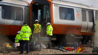 MEDFORD – MARCH 15: T officials inspecting the derailment of the Orange Line T train just outside the Wellington MBTA station in Medford, MA on March 16, 2021. (Photo by Matthew J. Lee/The Boston Globe via Getty Images)