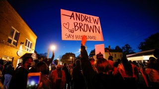 Protesters march in the evening after family members were shown body camera footage of a deputy sheriff shooting and killing Black suspect Andrew Brown Jr. last week, in Elizabeth City, North Carolina, April 26, 2021.