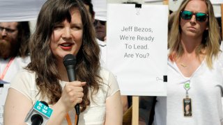 FILE - Emily Cunningham, left, speaks as Kathryn Dellinger, right, looks on during a news conference following Amazon's annual shareholders meeting, Wednesday, May 22, 2019, in Seattle. The National Labor Relations Board has found that two outspoken Amazon workers were illegally fired last year. Both employees, Emily Cunningham and Maren Costa, worked at Amazon offices in Seattle and publicly criticized the company, pushing it to do more to reduce its impact on climate change and to better protect warehouse workers from the coronavirus. The NLRB confirmed Monday, April 5, 2021 that it found merit in the case.