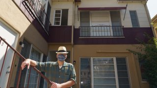 Nathan Long, a video game writer, poses for a picture outside his rental apartment courtyard in Glendale, Calif., Thursday, April 8, 2021. He and his wife, Lili, have been unsuccessful so far in their search for a home in Los Angeles.