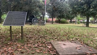 A brick base sits empty Tuesday, April 13, 2021, where chair carved out of limestone honoring Confederate President Jefferson Davis was stolen from Confederate Memorial Circle, a private section of Live Oak Cemetery in Selma, Ala. Police recovered the chair in New Orleans.