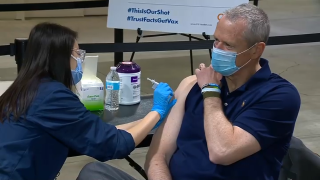 Massachusetts Gov. Charlie Baker gets a coronavirus vaccine shot at Boston's Hynes Convention Center mass vaccination site
