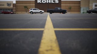 Vehicles sit parked in front of a Kohl’s department store in Ashland, Ky.