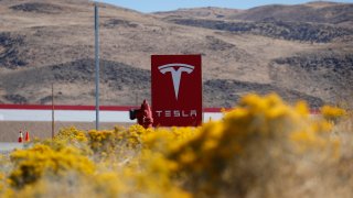 FILE - In this Oct. 13, 2018, file photo, a sign marks the entrance to the Tesla Gigafactory in Sparks, Nev. Egor Kriuchkov, a Russian citizen accused of offering a Tesla employee $1 million to enable a ransomware attack at the electric car company’s plant in Nevada, pleaded not guilty Thursday, Sept. 24, 2020, to a federal conspiracy charge.