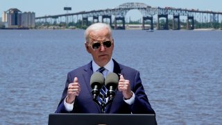 President Joe Biden speaks with the Interstate 10 Calcasieu River Bridge behind him, Thursday, May 6, 2021, in Lake Charles, La.