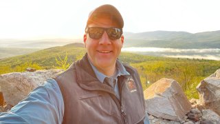 New Hampshire Gov. Chris Sununu takes a selfie as he began a daylong road trip with his cousin across the Granite State.