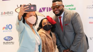 Boston Mayor Kim Janey and her daughter Kimesha take a selfie with David Ortiz at the Boston Arts Academy Honors in Norwood, Massachusetts, on Saturday, May 1, 2021.