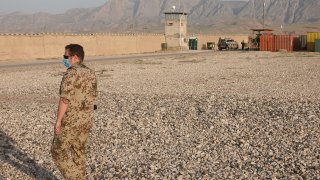 A soldier stands in front of an outer wall of the camp with a watchtower during a visit by Foreign Minister Maas (SPD, not in picture) to Camp Marmal in the northern Afghan city of Mazar-i-Sharif. Maas is visiting Afghanistan ahead of the Nato troop withdrawal to assess the situation on the ground. He has promised the country further support for the time after the withdrawal.