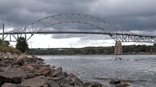 Automobiles and trucks cross the Bourne Bridge in Bourne, Massachusetts.