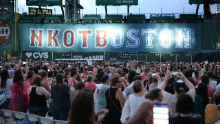 This July 8, 2017, file photo shows a New Kids on the Block banner inside Fenway Park in Boston before the group performed.