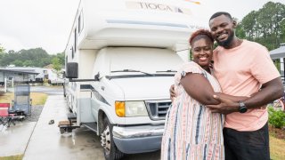 Karen and Sylvester Akpan in front of their RV.