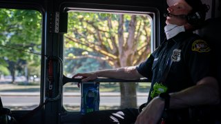 Salem Fire Department paramedic Justin Jones tries to stay cool after responding to a heat exposure call during a heat wave