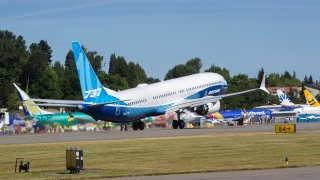 The final version of the 737 MAX, the MAX 10, passes other 737 MAX planes as it takes off from Renton Airport in Renton, Wash., on its first flight Friday, June 18, 2021. The plane will fly over Eastern Washington and then land at Boeing Field.