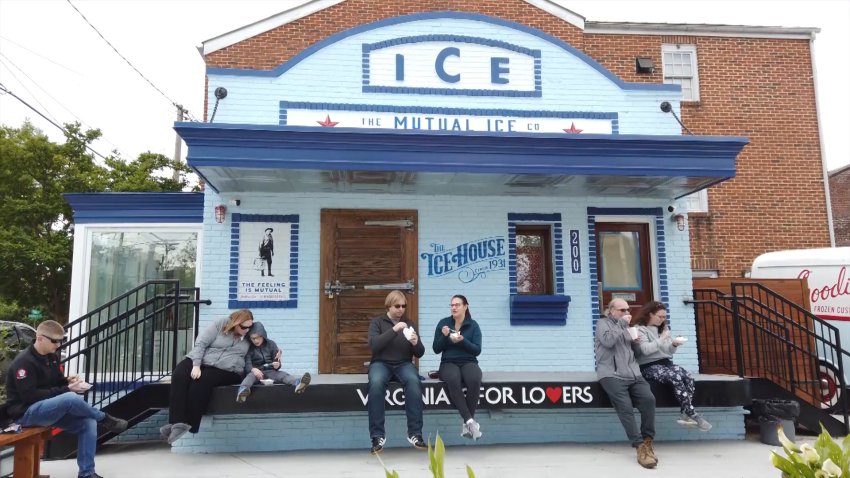 People eat dessert outside of a blue Ice House building.