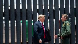 US President Donald Trump speaks with US Border Patrol Chief Rodney Scott (R) as they participates in a ceremony commemorating the 200th mile of border wall at the international border with Mexico in San Luis, Arizona, June 23, 2020.