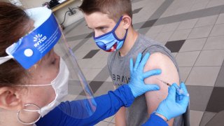Student Jack Herrington receives a dose of a coronavirus disease (COVID-19) vaccine on the campus of the University of Memphis in Memphis, Tennessee, July 22, 2021.