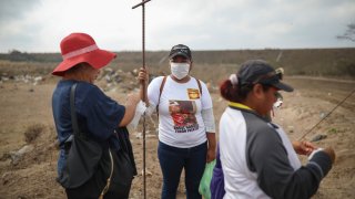 Lidia Lara Tobon, center, whose brother Angel Gabriel Tobon went missing, works with other relatives of the disappeared from the Solecito Collective, as they search for clandestine graves inside a municipal dump
