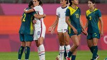 United States' Carli Lloyd, 2nd left, and Australia's Sam Kerr embrace each other at the end of their women's soccer match at the 2020 Summer Olympics, Tuesday, July 27, 2021, in Kashima, Japan. The game ended in a 0-0 draw.