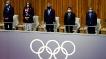 The President of the International Olympic Committee Thomas Bach and others stand during a moment of silence for victims of COVID-19 during the opening ceremony at the Olympic Stadium at the 2020 Summer Olympics, Friday, July 23, 2021, in Tokyo.