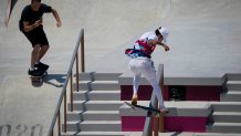 Skating legend Tony Hawk, left, films Nyjah Huston of the United States, center, as he takes part in a street skateboarding practice session at the 2020 Summer Olympics, Saturday, July 24, 2021, in Tokyo, Japan.