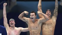United States men's 4x100m freestyle relay team Bowen Beck, Blake Pieroni, and Caeleb Dressel celebrate after winning the gold medal at the 2020 Summer Olympics, Monday, July 26, 2021, in Tokyo, Japan.