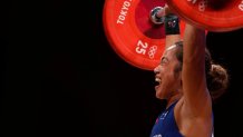 Hidilyn Diaz of Philippines celebrates as she competes and sets new world record and won the gold medal in the women's 55kg weightlifting event, at the 2020 Summer Olympics on July 26, 2021, in Tokyo, Japan.