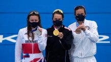 Gold medal winner Flora Duffy of Bermuda, center, hugs silver medalist Georgia Taylor-Brown of Great Britain, left, and Katie Zaferes of The United States during a medal ceremony for the women's individual triathlon competition at the 2020 Summer Olympics on July 27, 2021, in Tokyo, Japan.