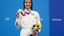 Regan Smith of the United States holds up her bronze medal for the women's 100-meter backstroke at the 2020 Olympics on July 27, 2021, in Tokyo, Japan.