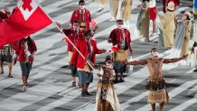 Flag bearers Malia Paseka and Pita Taufatofua of Team Tonga lead their team out during the Opening Ceremony of the Tokyo 2020 Olympic Games at Olympic Stadium on July 23, 2021 in Tokyo, Japan.